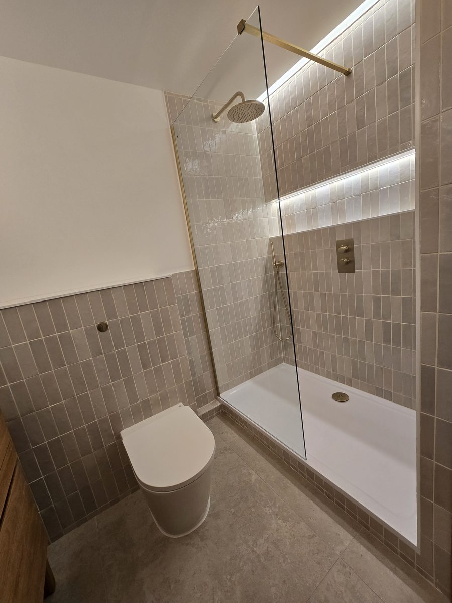 Rotherhithe second bathroom wide view with toilet, walk-in shower and gold fittings