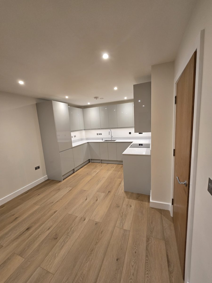 Stratford kitchen after renovation, with grey cabinetry and stone countertop